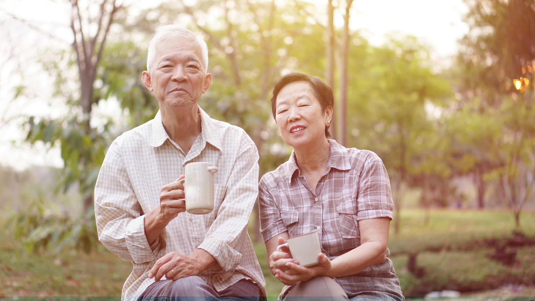 Casual Asian couple citizen drinking tea in mornign garden l